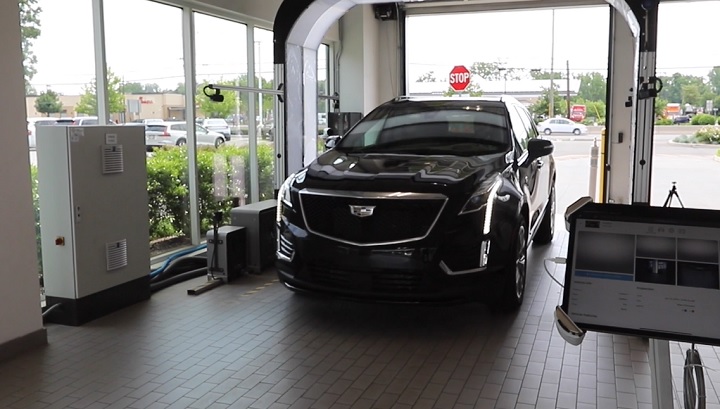 A UVeye inspection system inspects a Cadillac at a GM dealer.