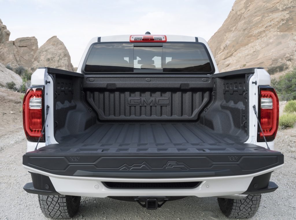 GMC logo in the 2023 GMC Canyon's bed with tailgate down. 