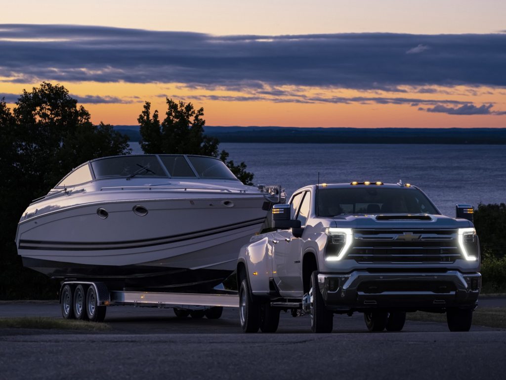 Front view of the 2024 Chevy Silverado HD towing a boat.