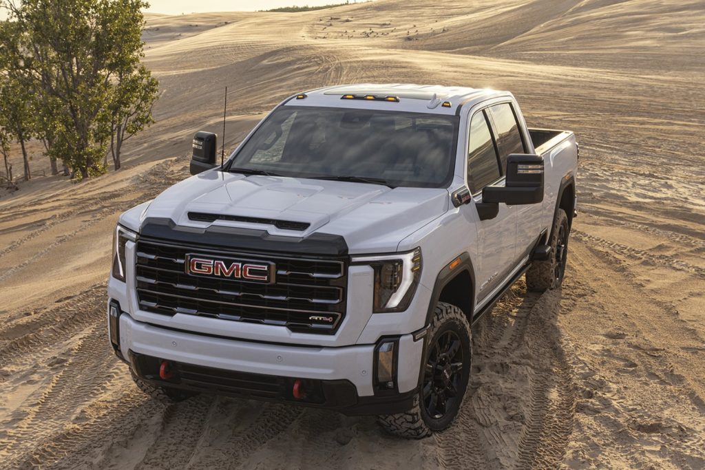 A front three-quarters view of the AT4 trim of the 2024 GMC Sierra HD.