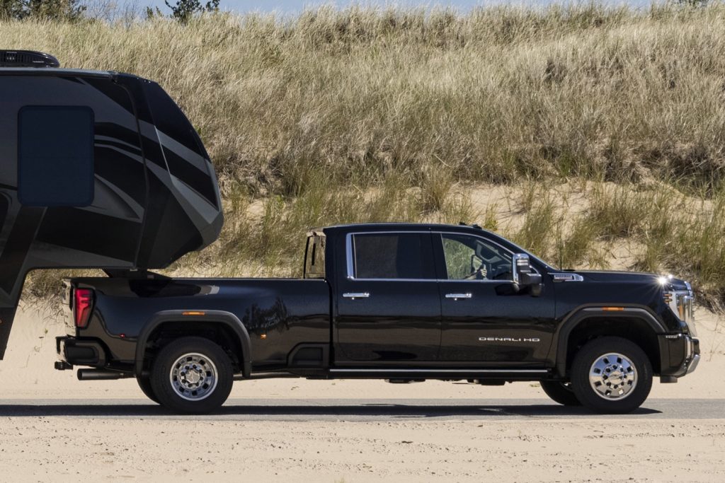 The refreshed 2024 GMC Sierra HD towing a trailer.
