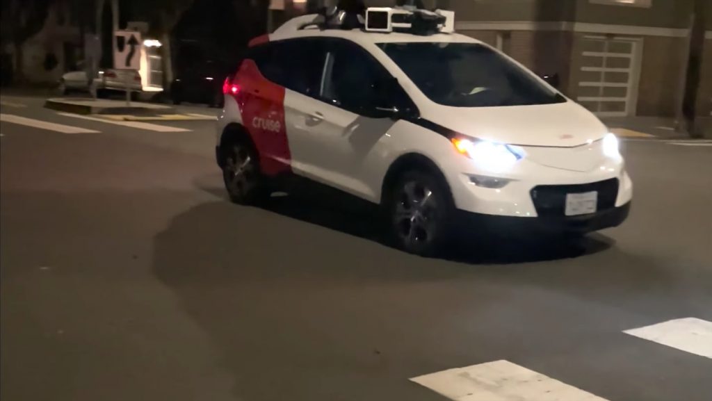 Front three-quarters view of a Cruise Chevy Bolt AV navigating the streets.
