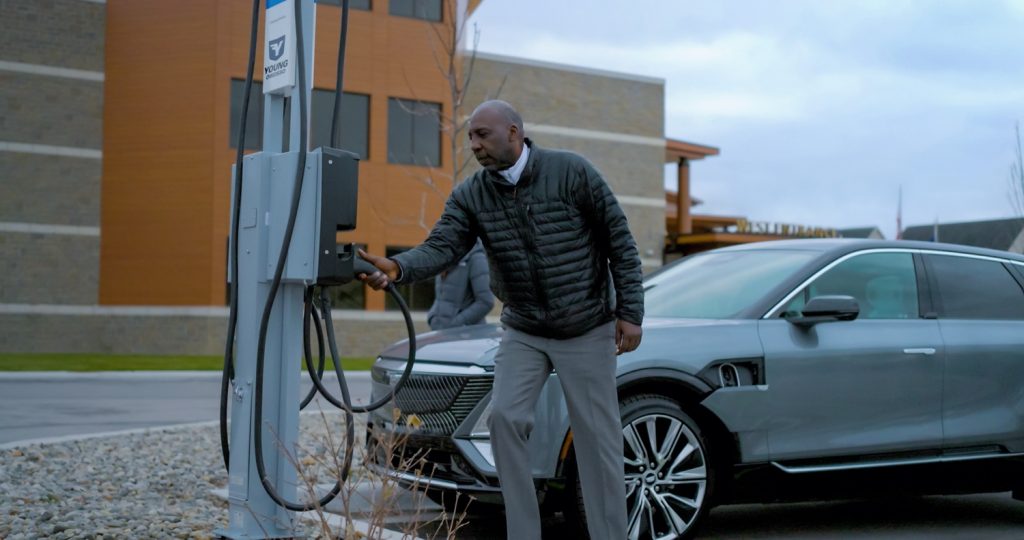 Customer charging an EV at a GM dealer.
