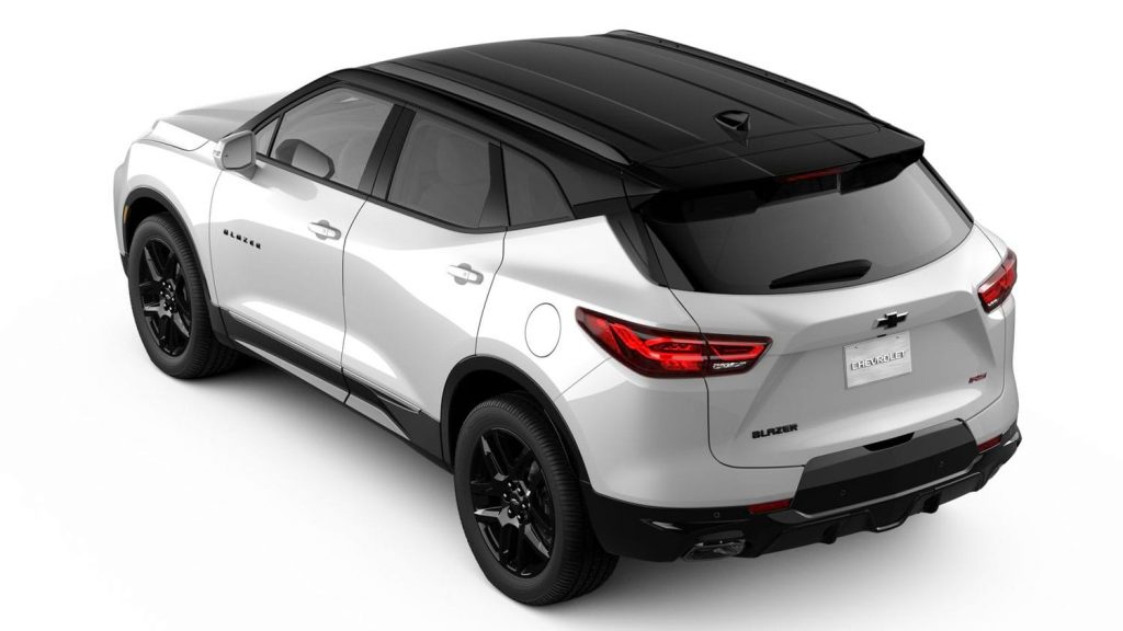 Rear three-quarters view of 2023 Chevy Blazer RS with Iridescent White paint and Gloss Black aluminum wheels.