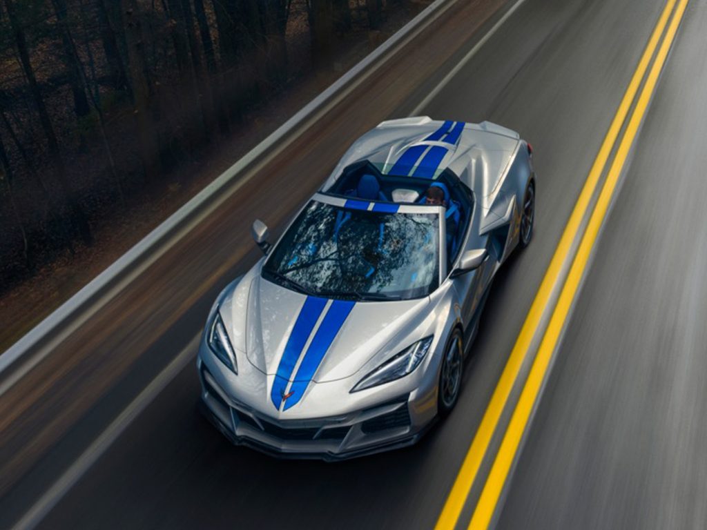 The new hybrid 2024 Corvette E-Ray attacks a two-lane road.