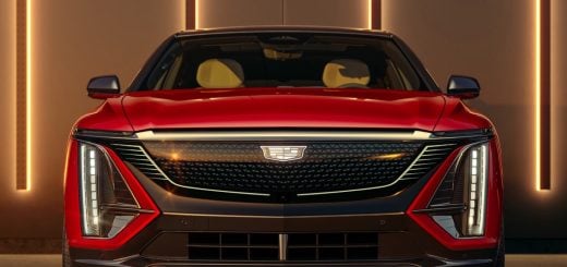2024 Cadillac Lyriq - Sport - 600E4 - Radiant Red Tintcoat GNT - Press Photos - Exterior 003 - front - Cadillac logo badge on illuminated grille - DRL daytime running lights - headlights