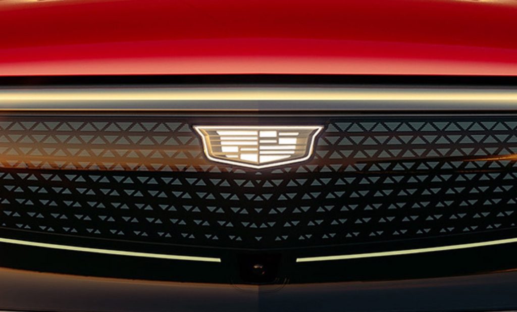 Cadillac To Reveal Three EVs In 2023   2024 Cadillac Lyriq Sport 600E4 Radiant Red Tintcoat GNT Press Photos Exterior 004 Front Cadillac Logo Badge On Illuminated Grille 1024x618 