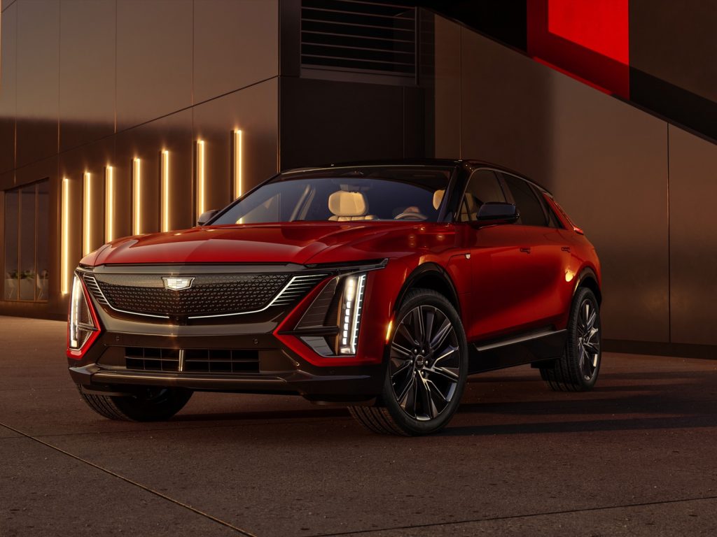 A front three-quarters view of the 2024 Cadillac Lyriq with illuminated badge.