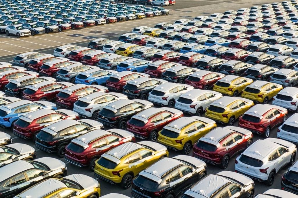 Large parking lot of new cars waiting for delivery and export, at