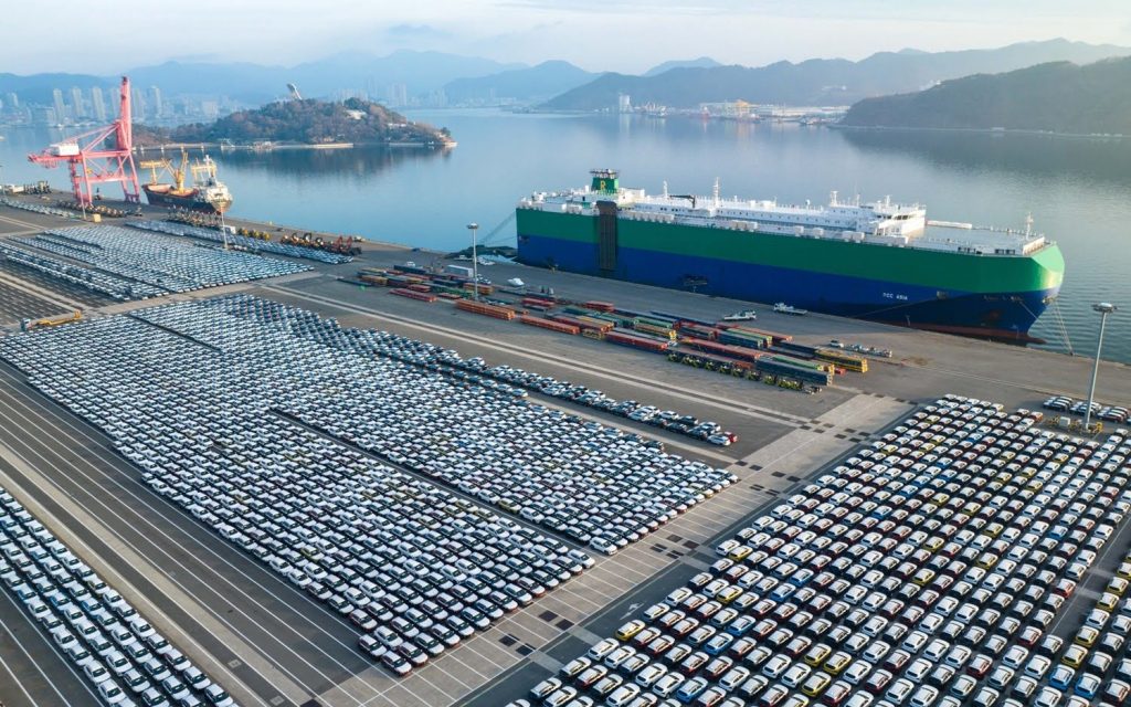 Aerial view of 2024 Chevy Trax units near a cargo ship.