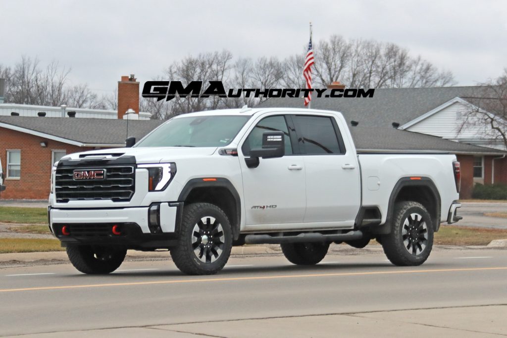 A 2024 GMC Sierra HD AT4 in Summit White out on public roads.