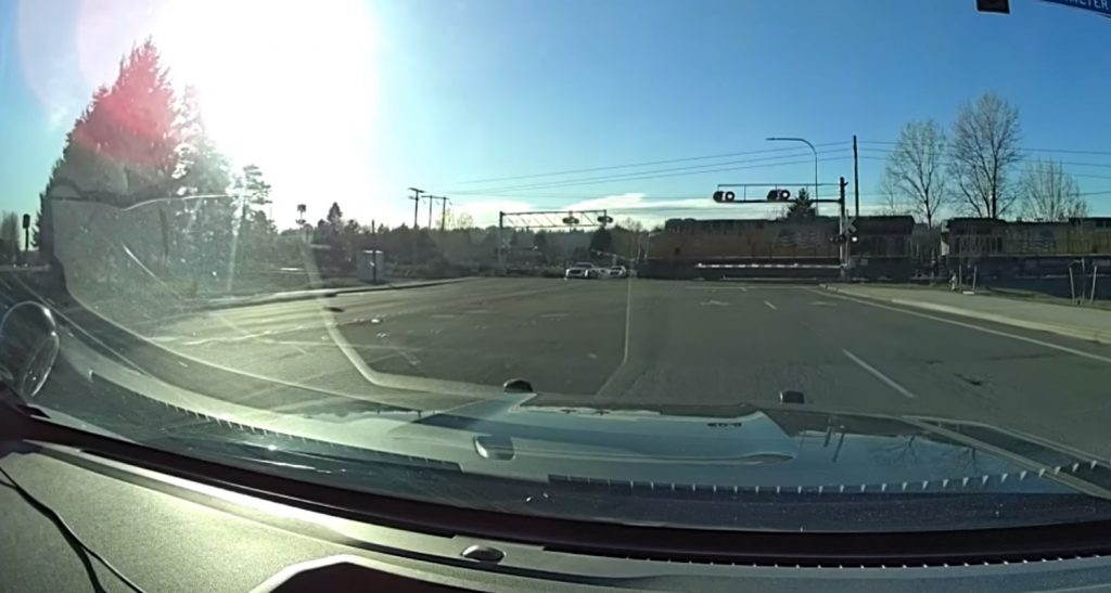 Dash cam footage of a police chase involving a Cadillac sedan.