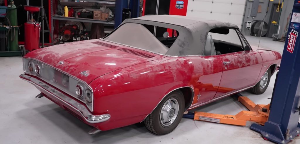 The rear end of an unrestored 1965 Chevy Corvair.