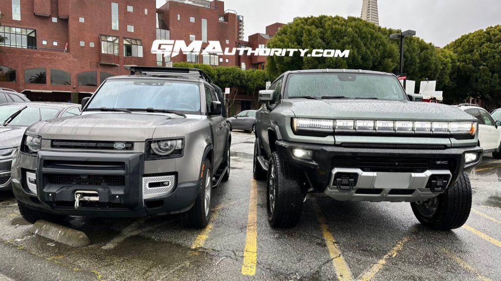 The GMC Hummer EV SUV parked next to the Land Rover Defender.