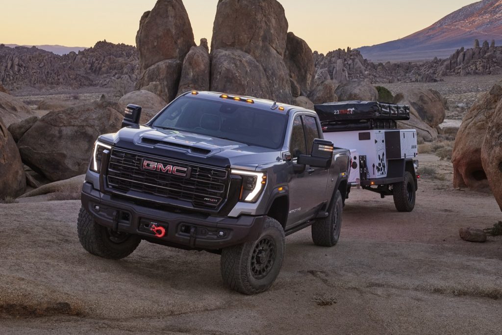 Front three quarters view of the 2024 GMC AT4X AEV Edition towing.