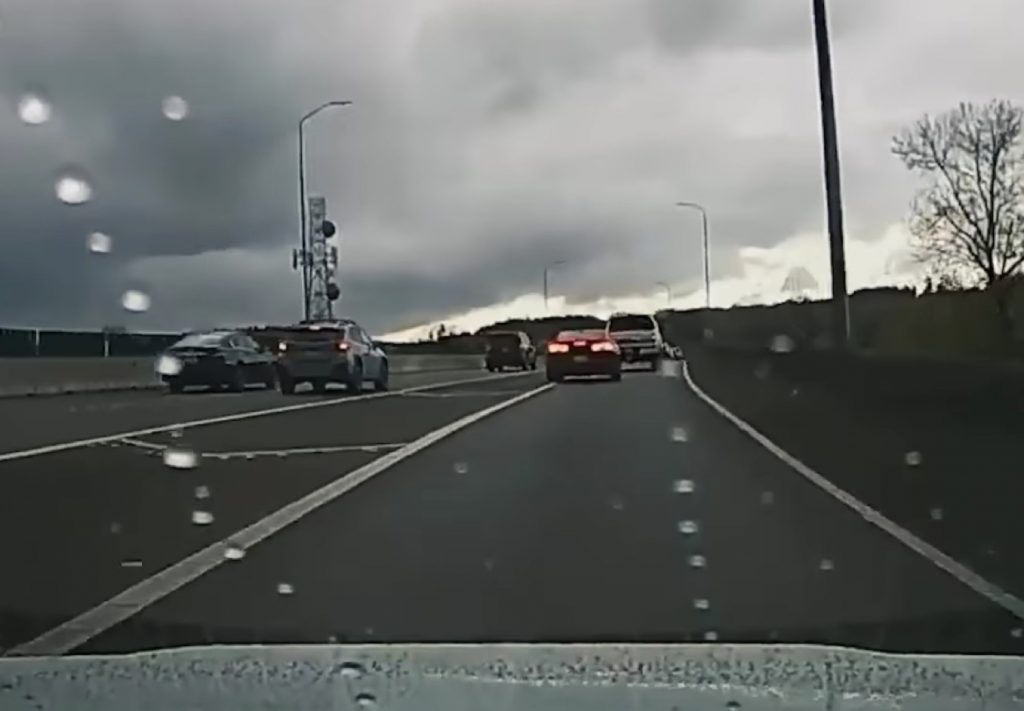 Screenshot from a viral video showing a Chevy Camaro crashing on the highway.