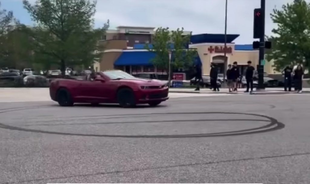 Chevy Camaro Convertible exits a car meet before wrecking.