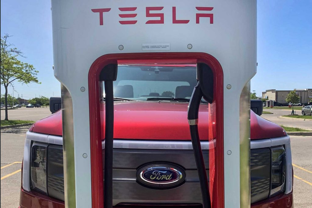 Photo of a Ford F-150 Lightning using a Tesla Supercharger.