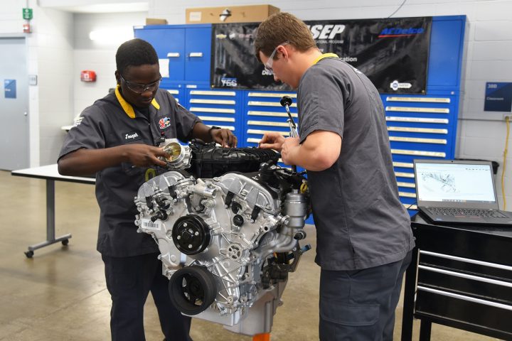Technicians working on an engine at a shop that could benefit from right to repair legislation.