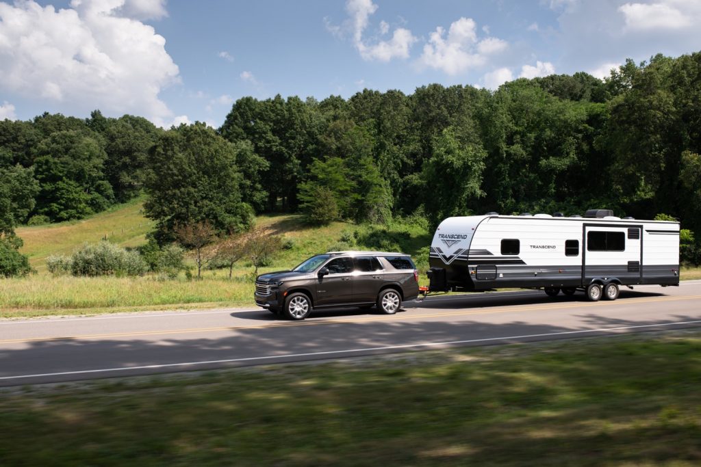 Shown here is the Chevy Tahoe full-size SUV in the range-topping High Country trim towing a large RV.