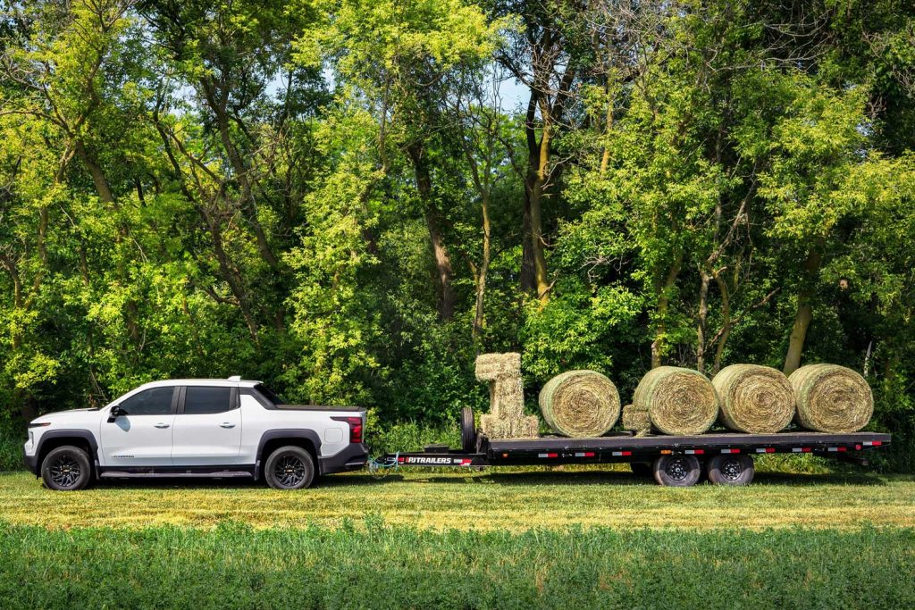 The 2024 Chevy Silverado EV WT tows hay, announcing a maximum towing capacity of 10,000 pounds.