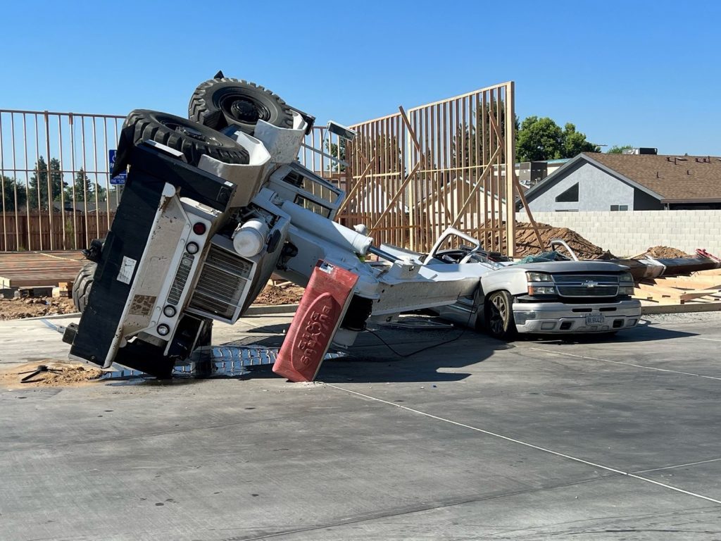 A Chevy Silverado is flattened by a construction crane in California.