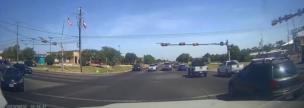 Screenshot from a viral video showing a Chevy Traverse crashing into a utility pole.