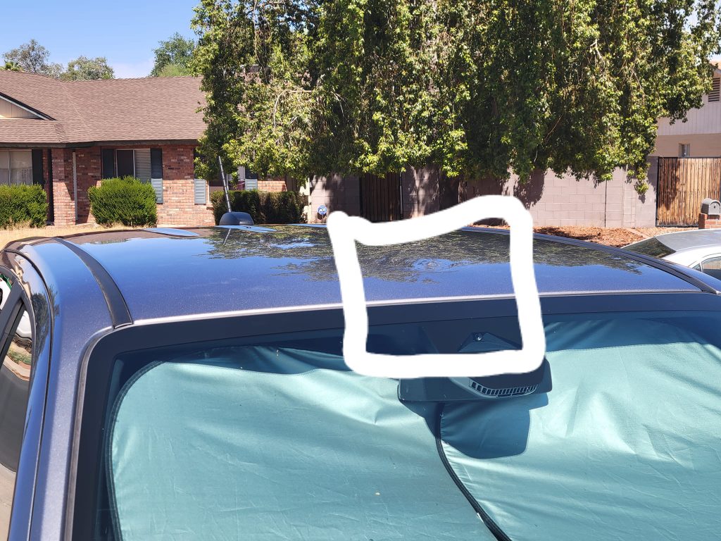 A 2023 Chevy Colorado with a dented roof due to a touchless car wash service.