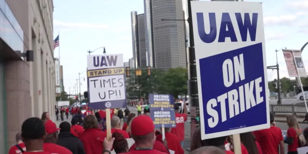 UAW protesters holding signs.