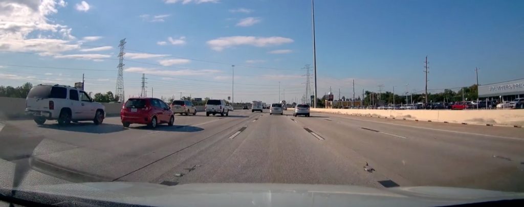 Screenshot from a recent viral video showing a Chevy Tahoe crashing into the concrete barrier.