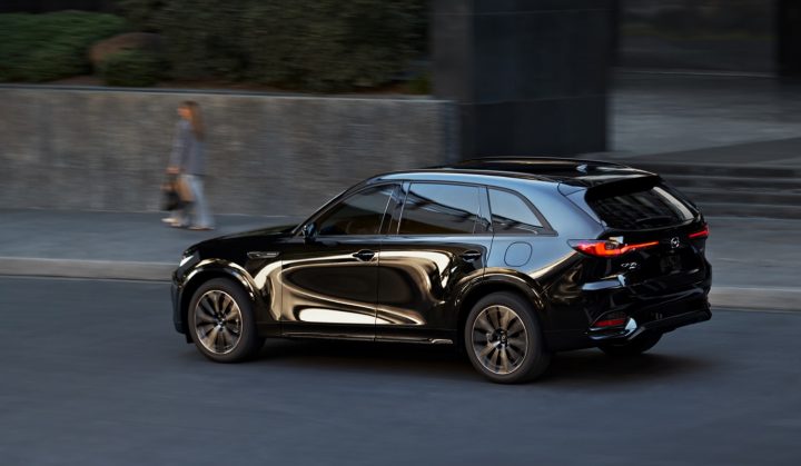 The Mazda CX-70 drives down the road.