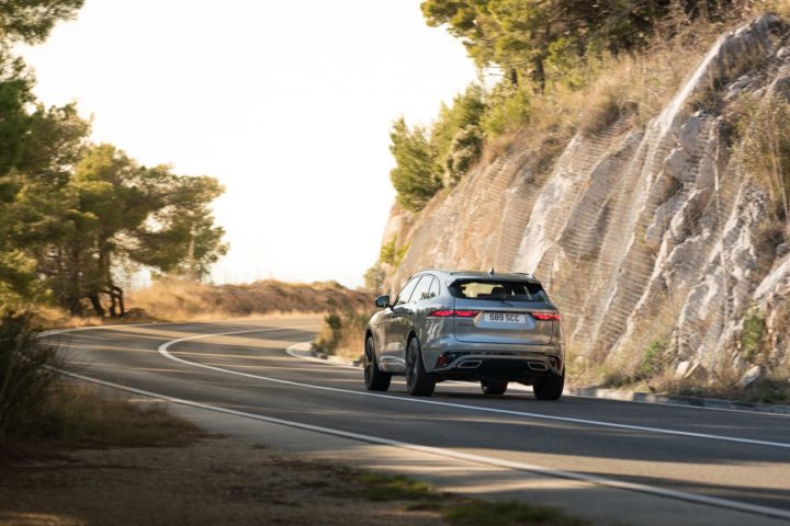 The Jaguar F-Pace on a two-lane road.
