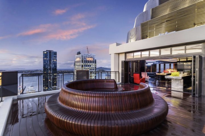 A luxury condo in New Zealand with a Chevy Impala in the background.