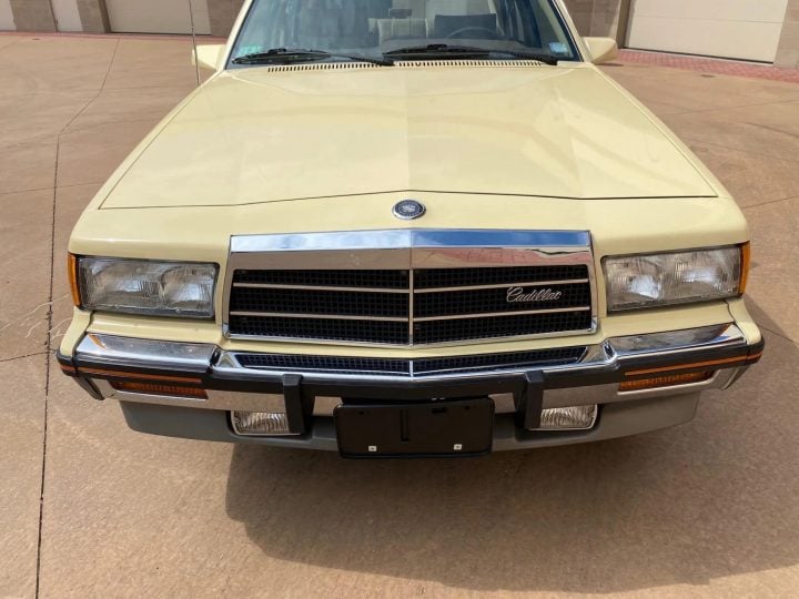 The front end of a 1987 Cadillac Cimarron.