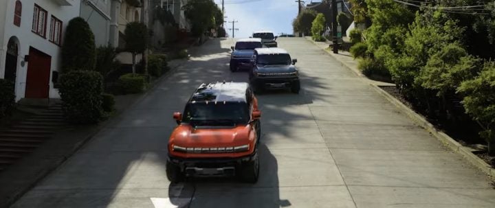 A line of GMC Hummer EV SUVs in San Francisco.