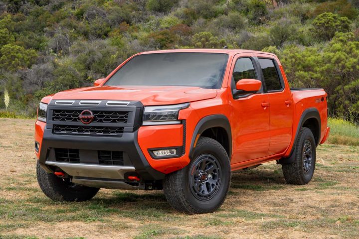 A front three quarters view of the 2025 Nissan Frontier PRO-4X in Afterburn Orange.