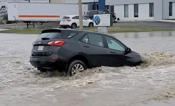 A GM crossover sinks in a puddle.