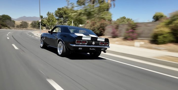 The rear three-quarters view of a custom 1968 Chevy Camaro.