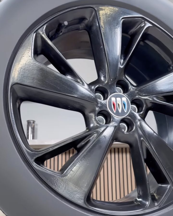 A life-sized recreation of the 2024 Buick Envision ST wheel in chocolate.