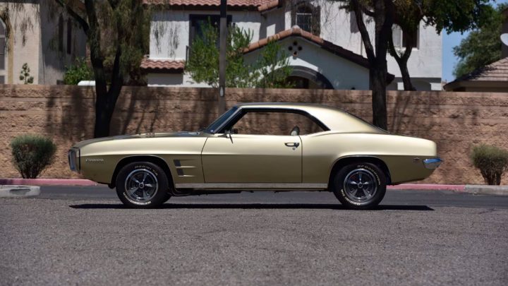 Side view of the Antique Gold 1969 Pontiac Firebird heading to auction.