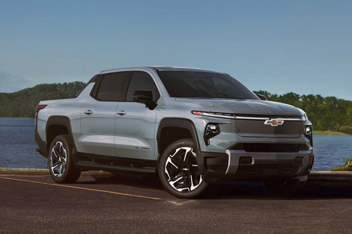 Chevy Silverado EV parked in front of a lake.