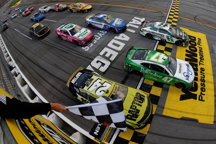 Photo of the finish of the NASCAR race at Talladega in October 2024, showing three cars taking the checkered flag abreast. NASCAR can now penalize OEMs for race manipulation.