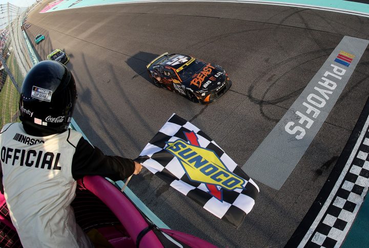 Image of NASCAR Chevy racers on track behind the leaders at Homestead-Miami.