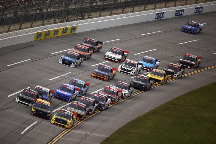 A NASCAR Chevy truck goes sideways at the front of the pack at Talladega.