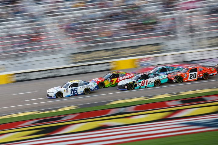 AJ Allmendinger in the No. 16 NASCAR Chevy Camaro SS leading the pack on the track.