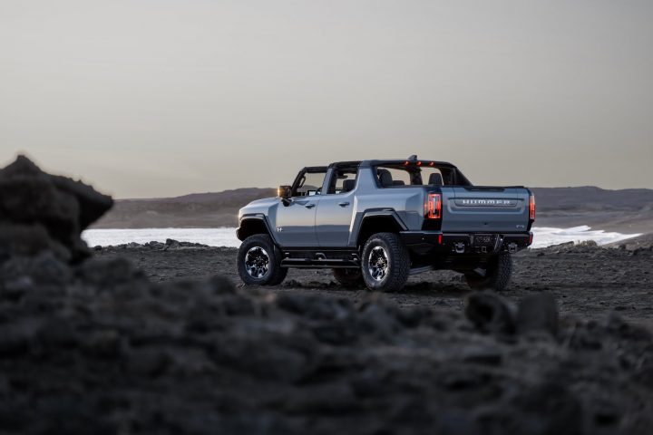 A rear three quarters angle view of the 2025 GMC Hummer EV Pickup.