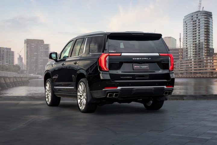 2025 GMC Yukon Denali rear three quarter angle.