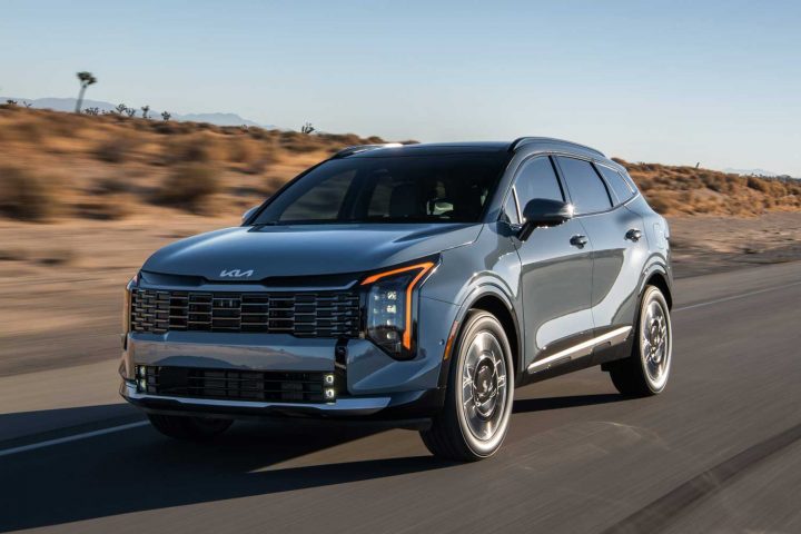 2026 Kia Sportage driving on a desert road.