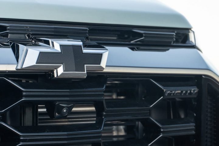 View of the black Chevrolet logo on the grille of a crossover.