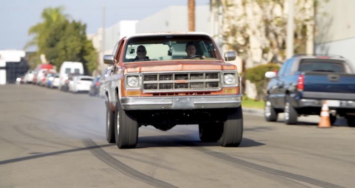 A modified 1978 GMC Jimmy does a burnout.